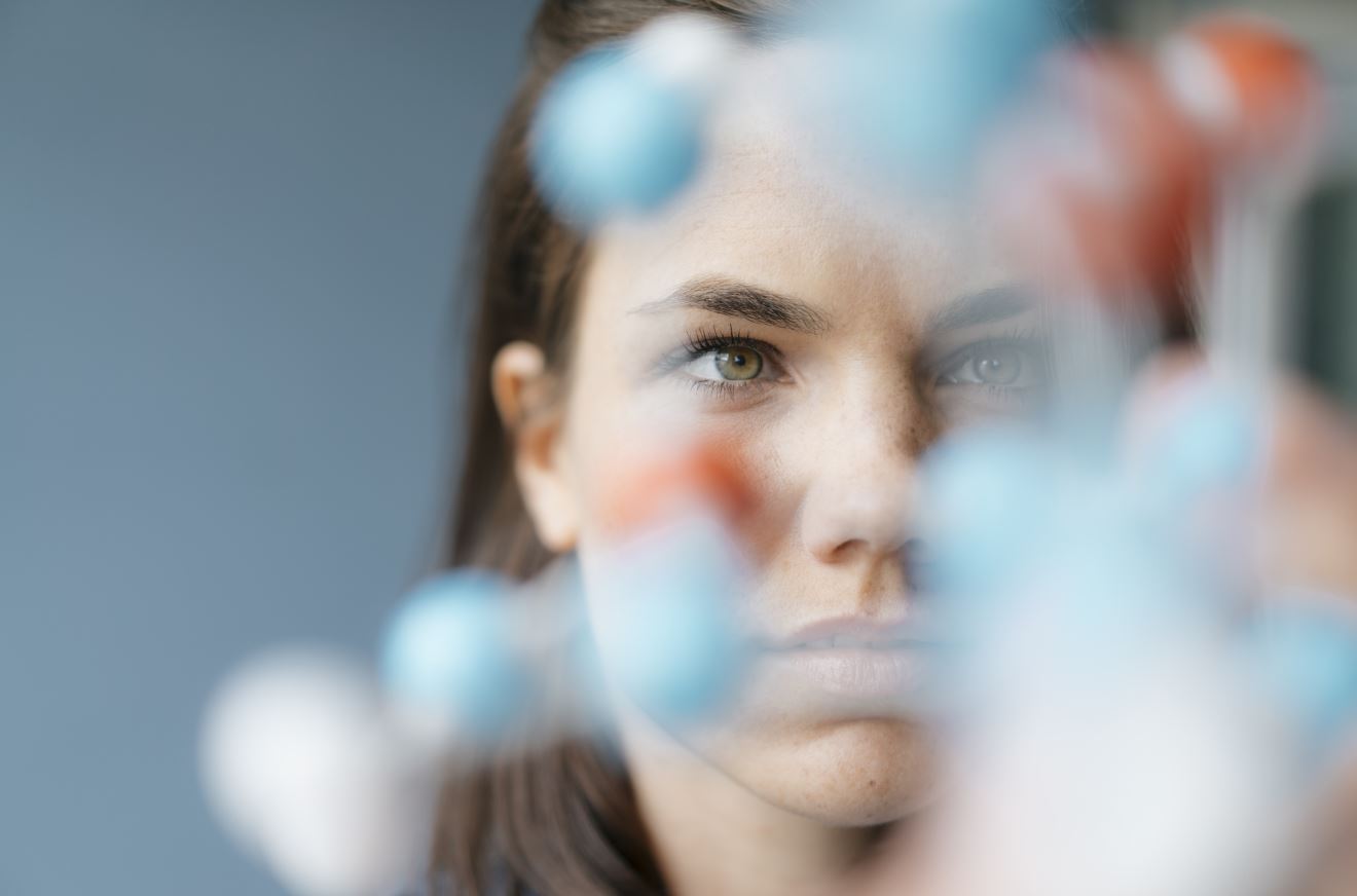 Scientist looking at molecular model