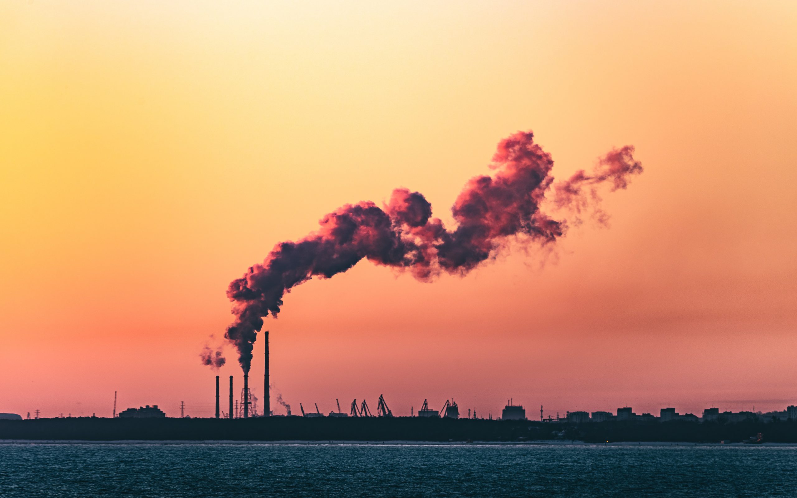 Factory with smoke or steam cloud above