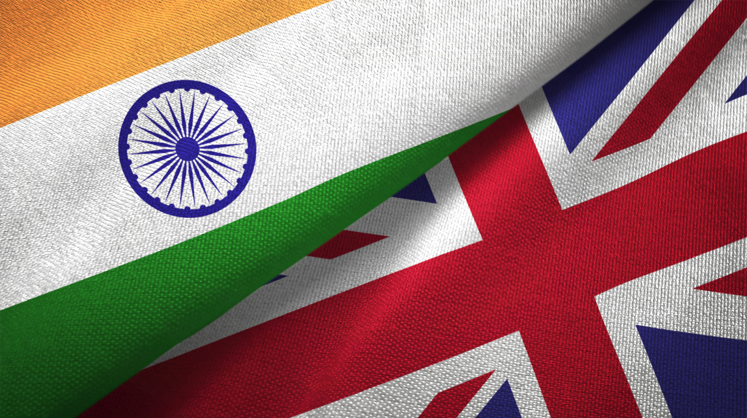 India and United Kingdom flags together relations textile cloth, fabric texture.